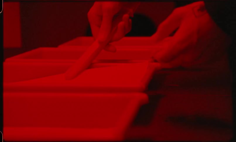 Man develops photos in darkroom