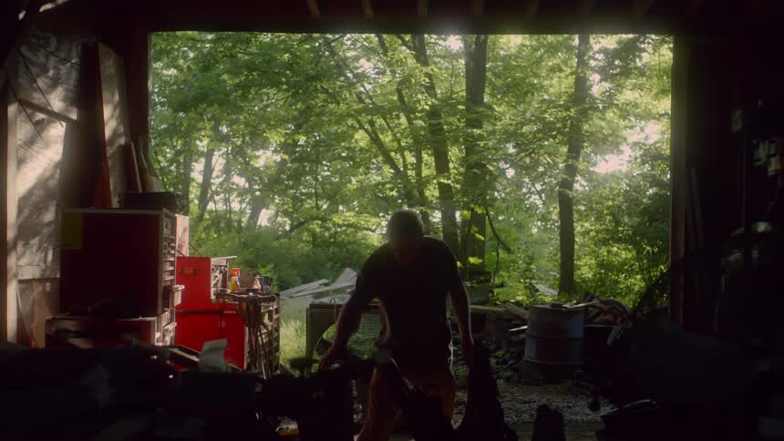Elderly man working in his shed