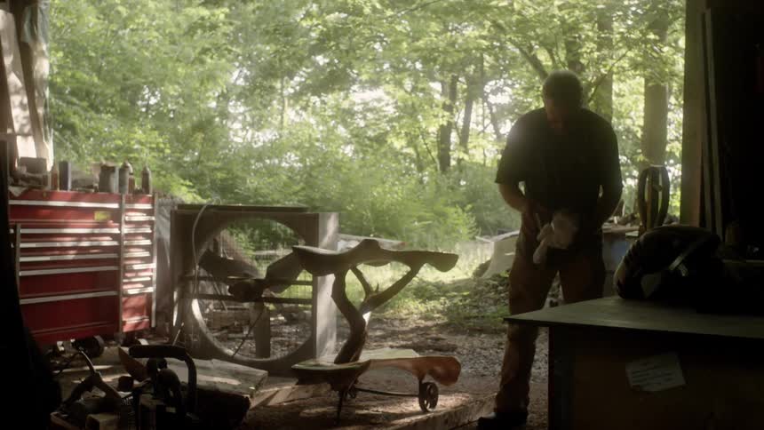 Man carpenter cleaning his piece of artwork