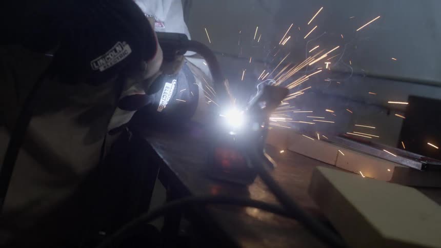 A person is using a welding gun