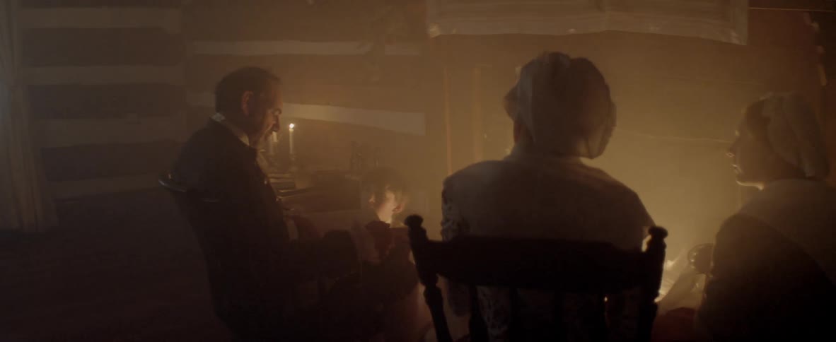 A group of vintage themed people sit around a fireplace