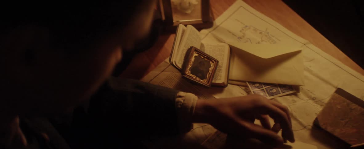 Soldier reading a letter under orange light