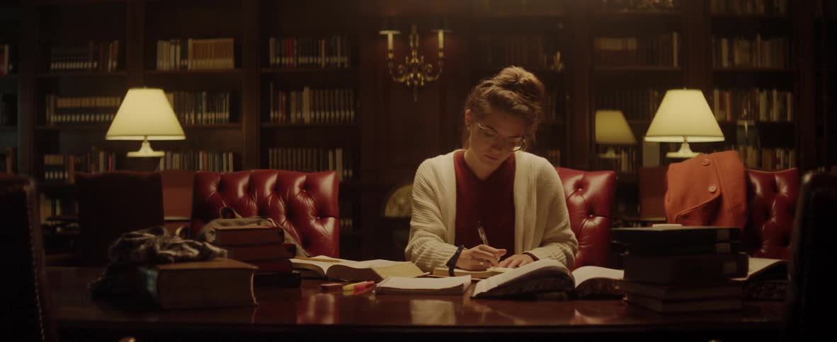 A woman studies in a library