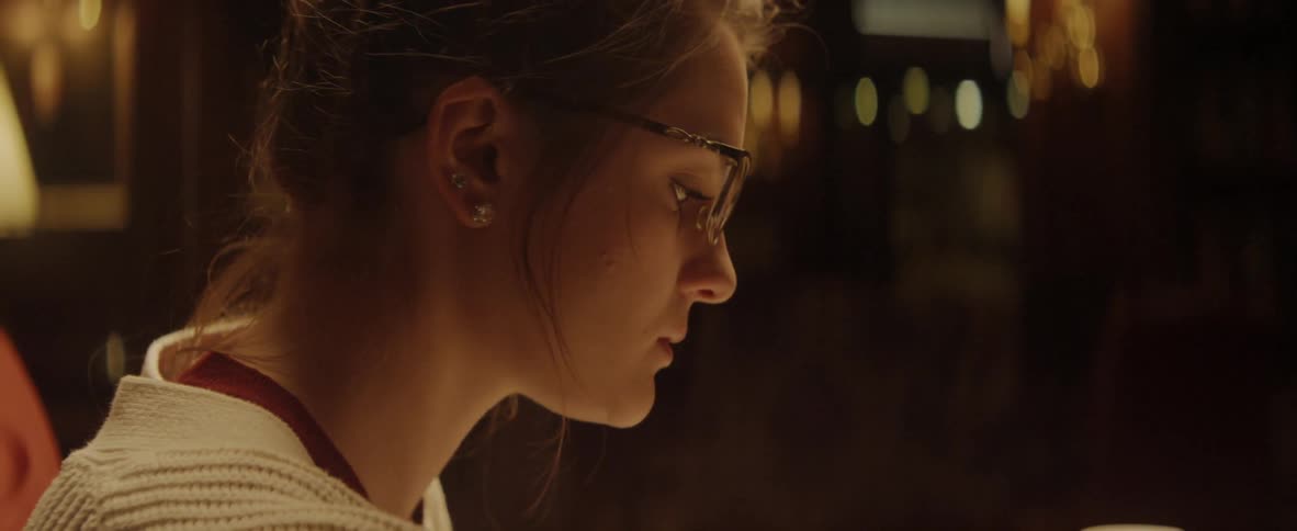 A woman studies in a dark room