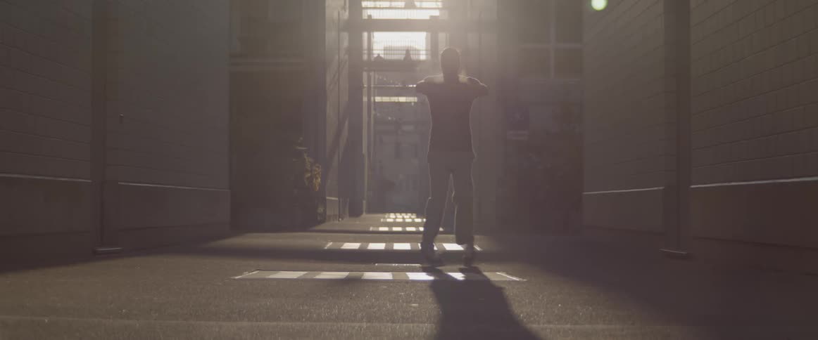 Man doing a modern dance at the downtown street on the morning