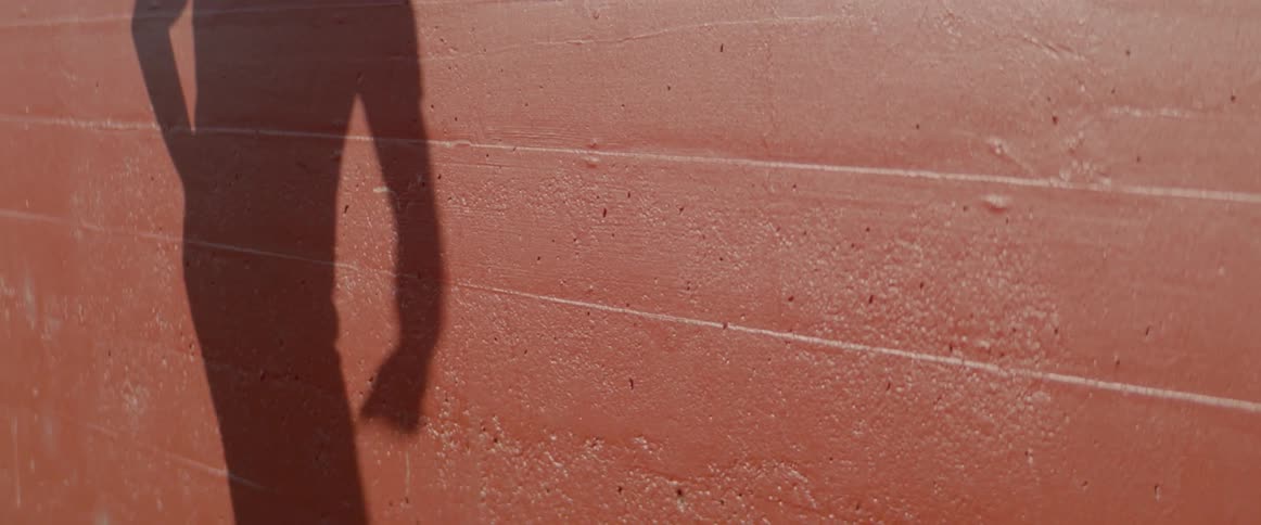 Shadow projection on the wall of a man dancing