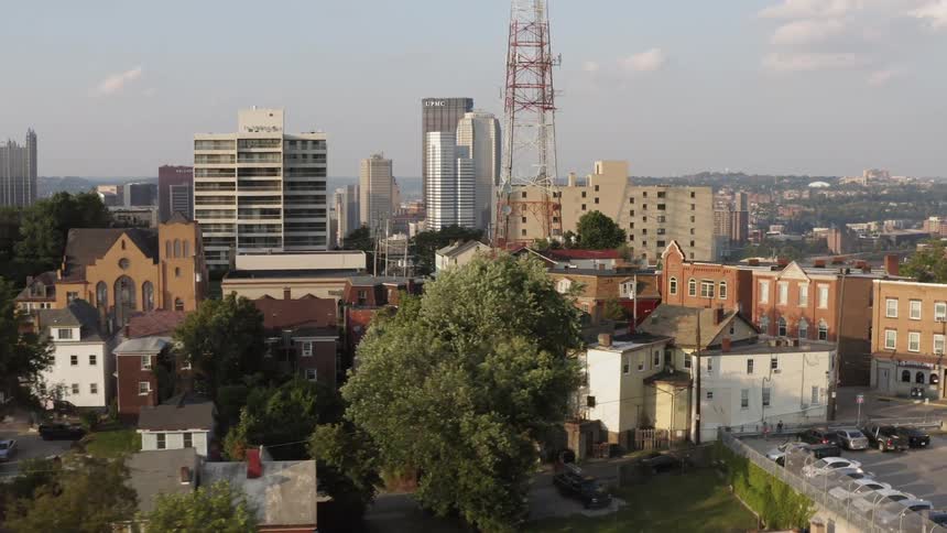 An aerial view of a downtown city and skyline is displayed