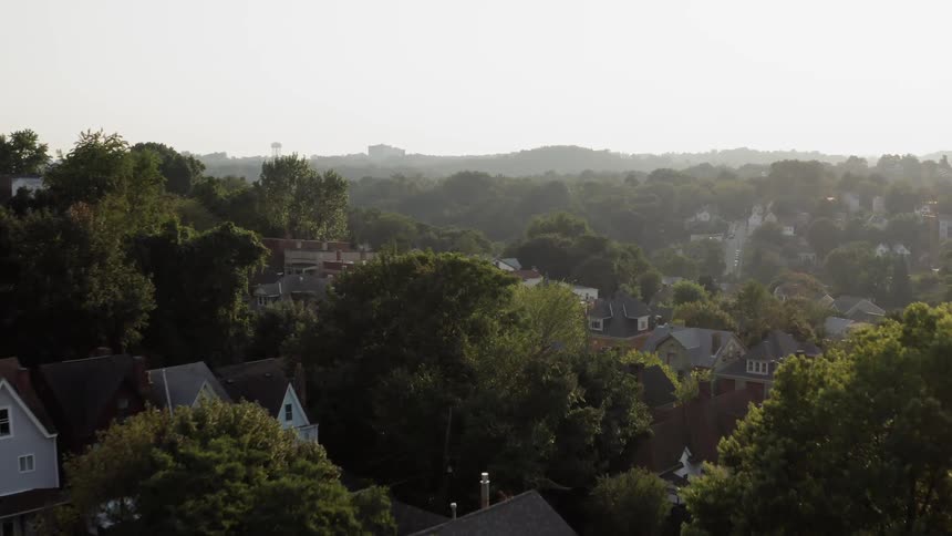 A small town in the hills with trees everywhere