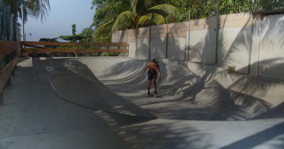 A man is skateboarding in a skate park