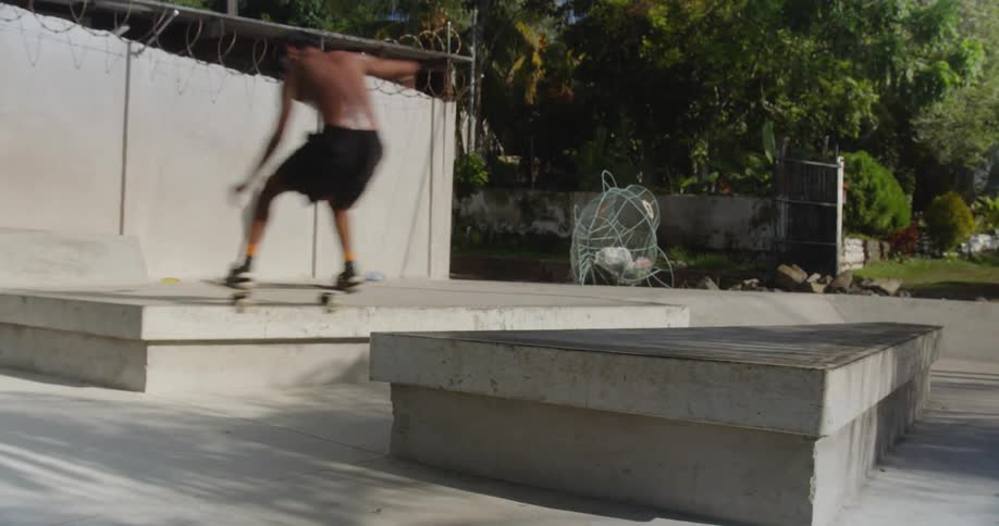 A man does tricks on a skateboard in a skate park
