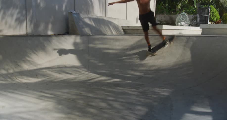 A teenager skateboards up a ramp