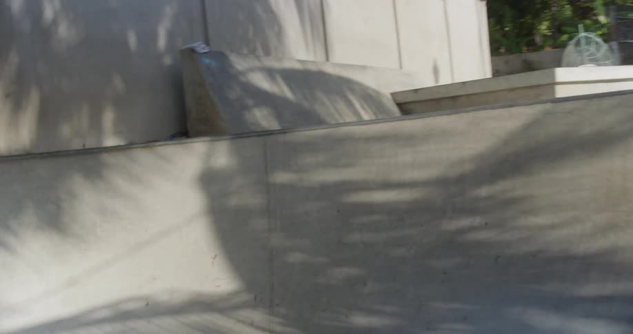 A person with black shorts skating in a skate park