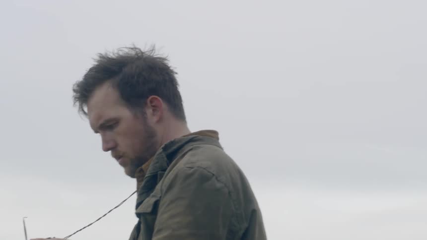 A man looking at the compass on the journey