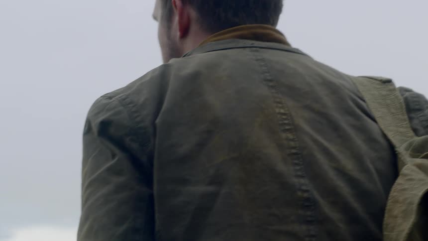 A man looks around at his surroundings and starts walking