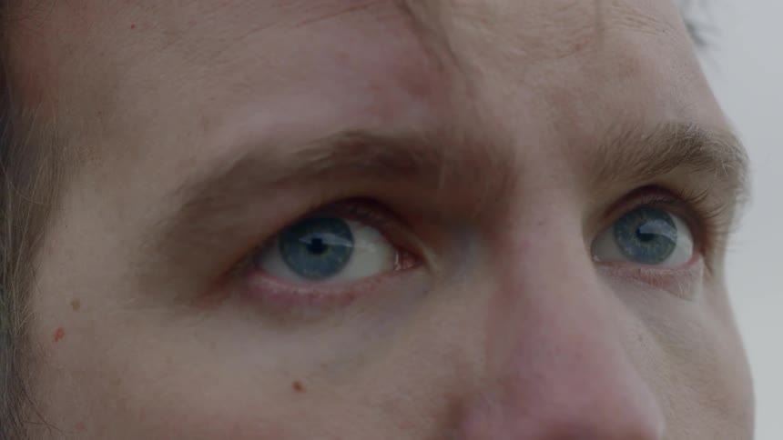 Close up of a man looking around him