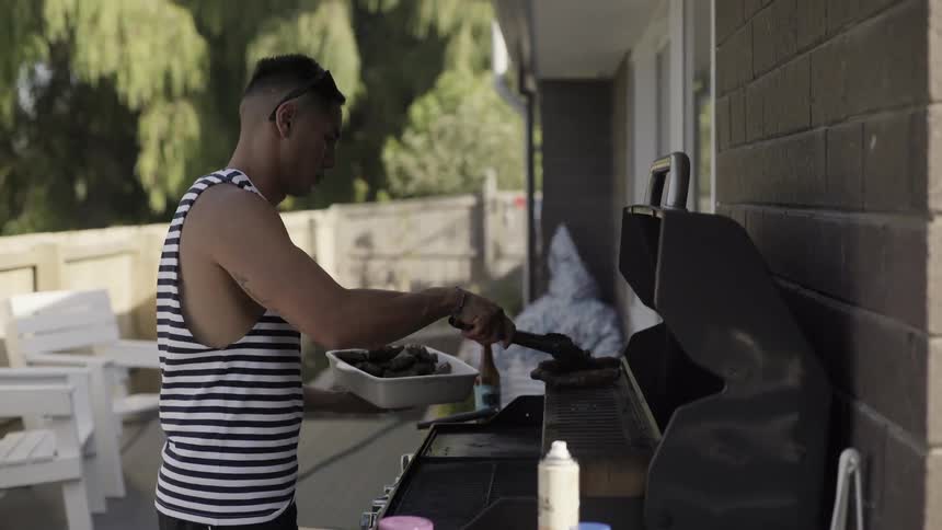 Someone Grilling Juicy Steaks Outdoors Over Open Flame in Casual Barbecue Scene.