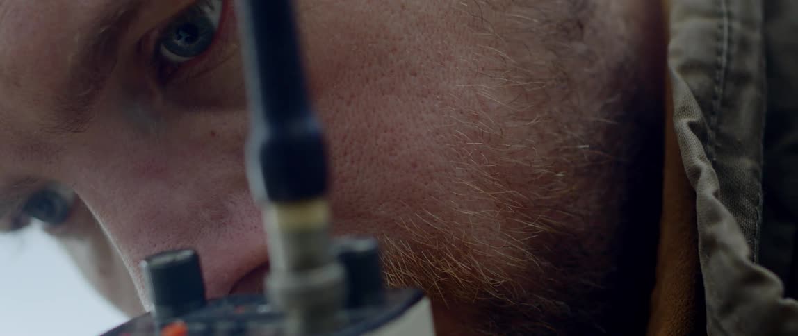 A man listens into a satellite phone