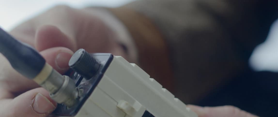 A man adjust settings on a satellite phone