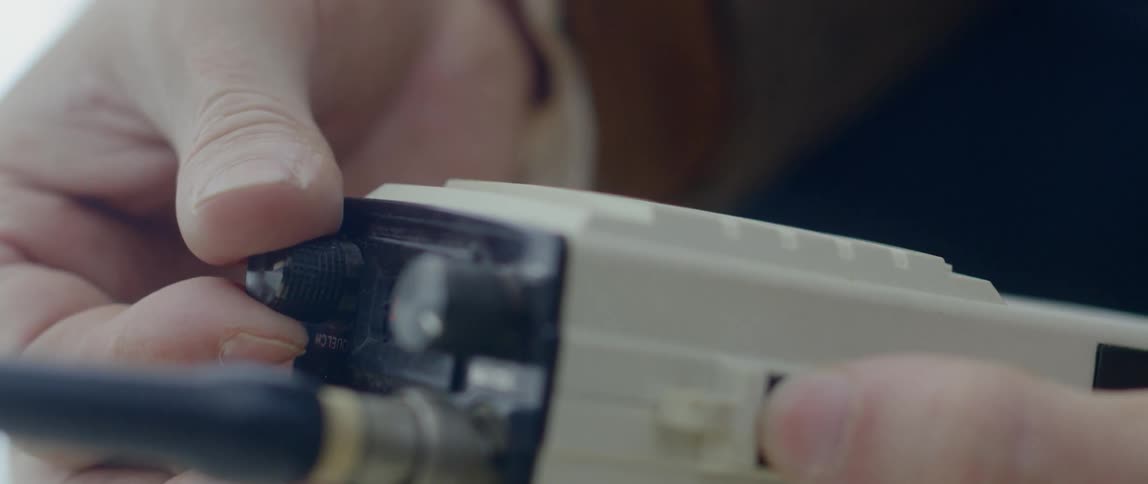 A man adjusts controls on a walkie talkie