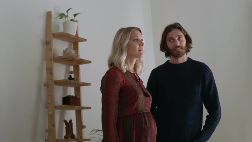 A woman and man are standing in a room