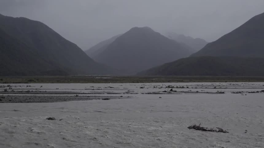 Water Flows in Front of Mountains Creating Peaceful Mountain Stream and Nature Ambience.