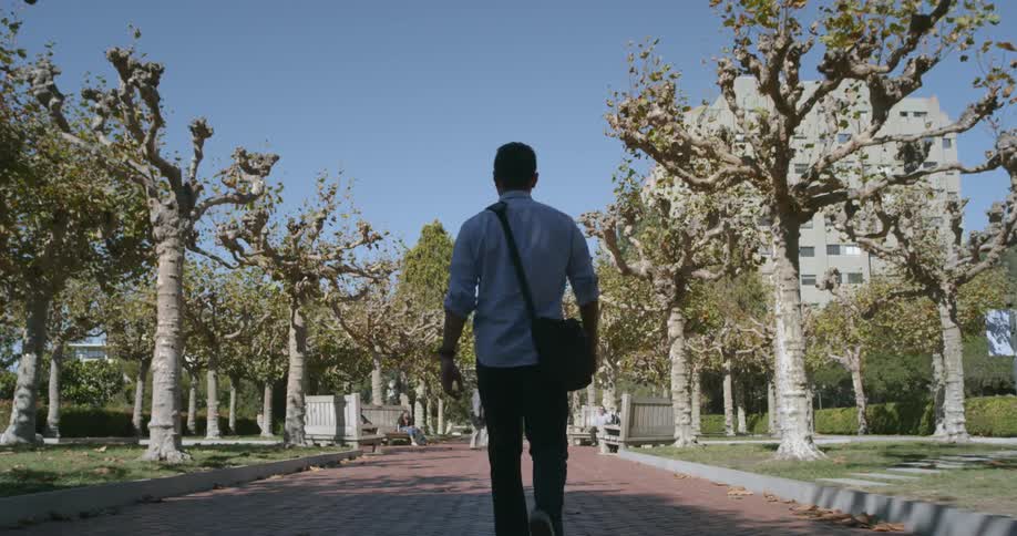A man is walking on a school campus
