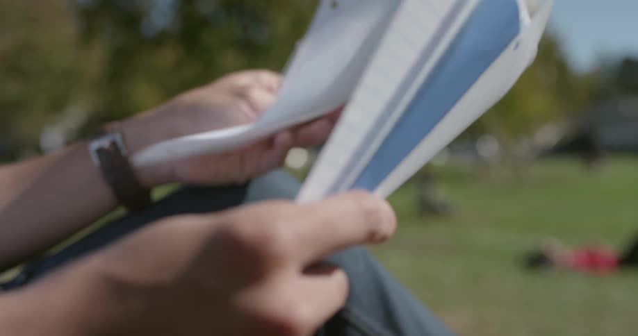 A young man looks through some papers