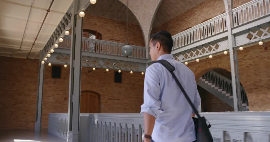Man walks through the hallways of a building