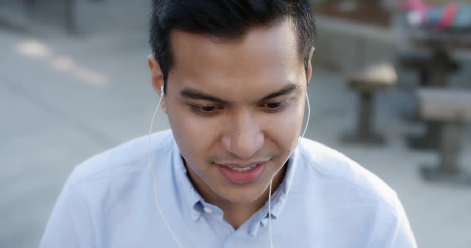A young man with his headphones in talks