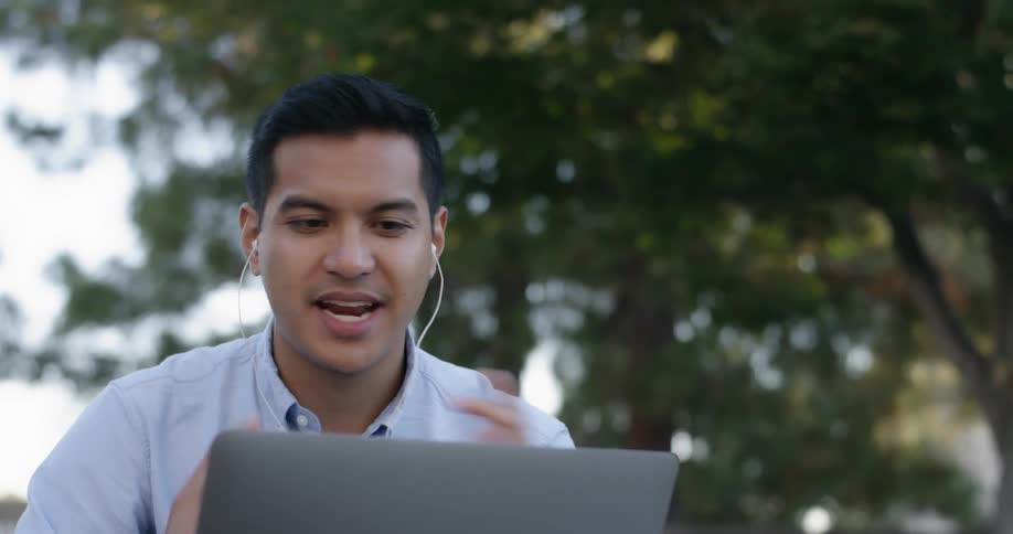 A man on a laptop video chatting with someone