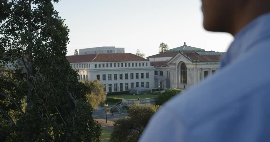 Man looks at university campus buildings