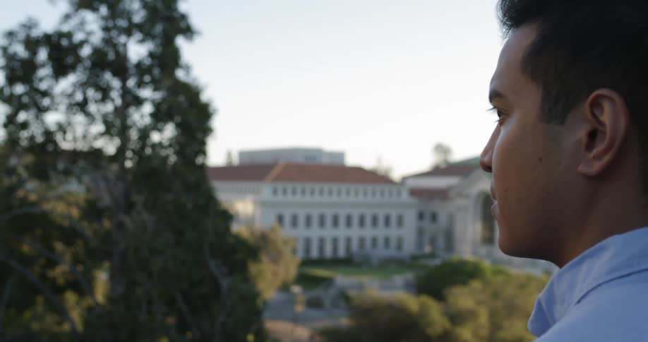 A man is looking out over the campus