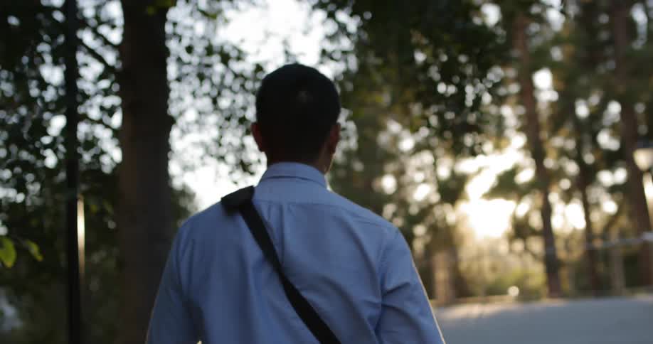 A man is walking towards the building
