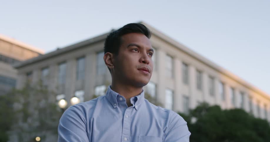 A man stands in front of a building