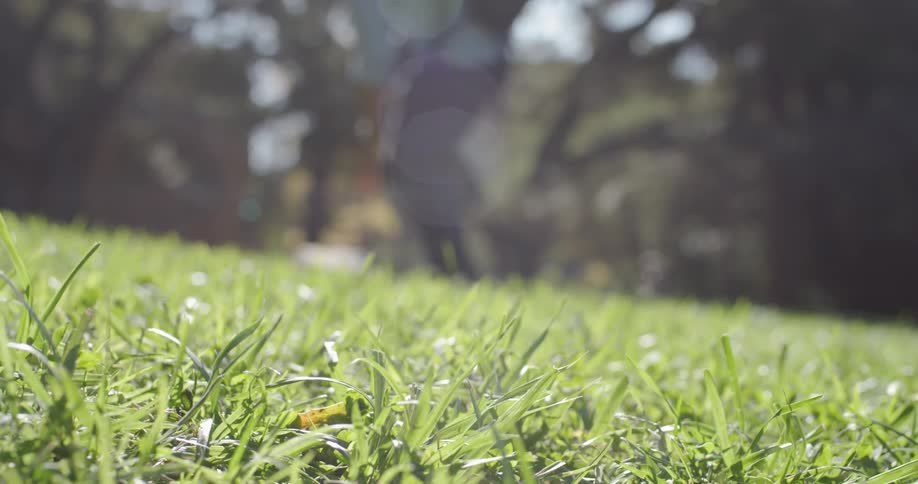 Man standing up and picking backpack from ground