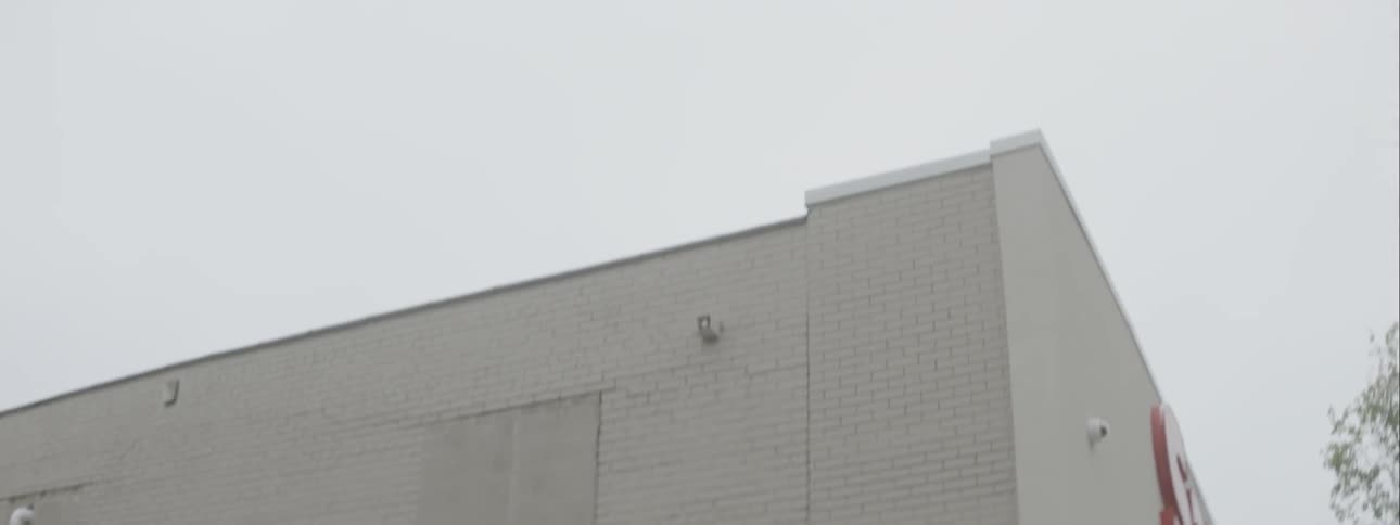 Lights flash on a police car outside of a store