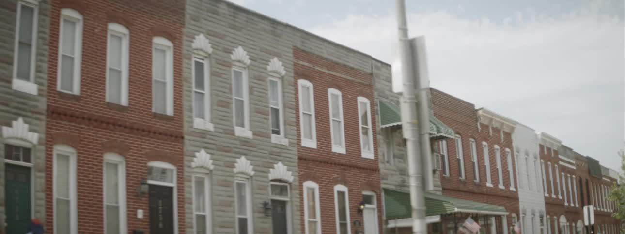 The street is lined with apartment buildings