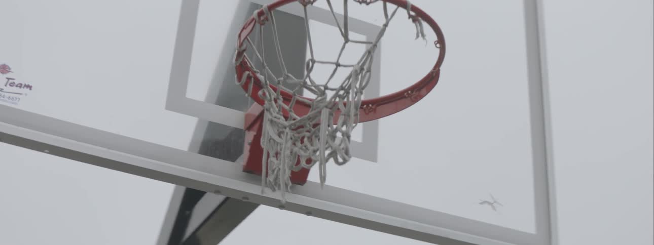 A basketball hoop stands on an outdoor court