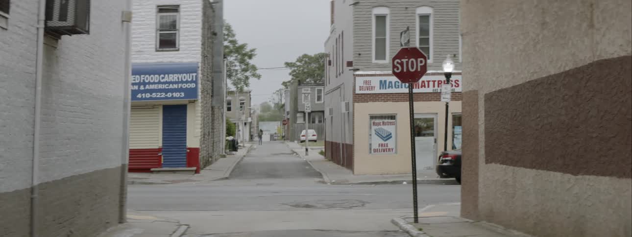 Vehicles pass along a small town street