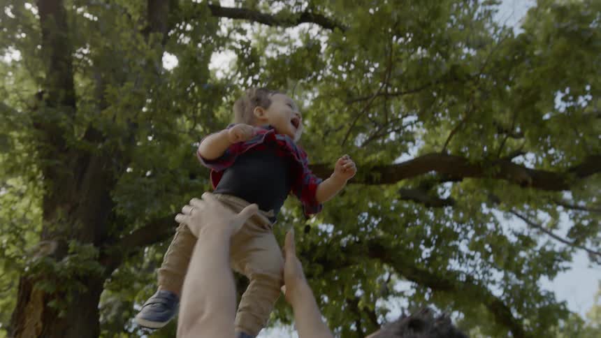 Father is playing with his child outdoors