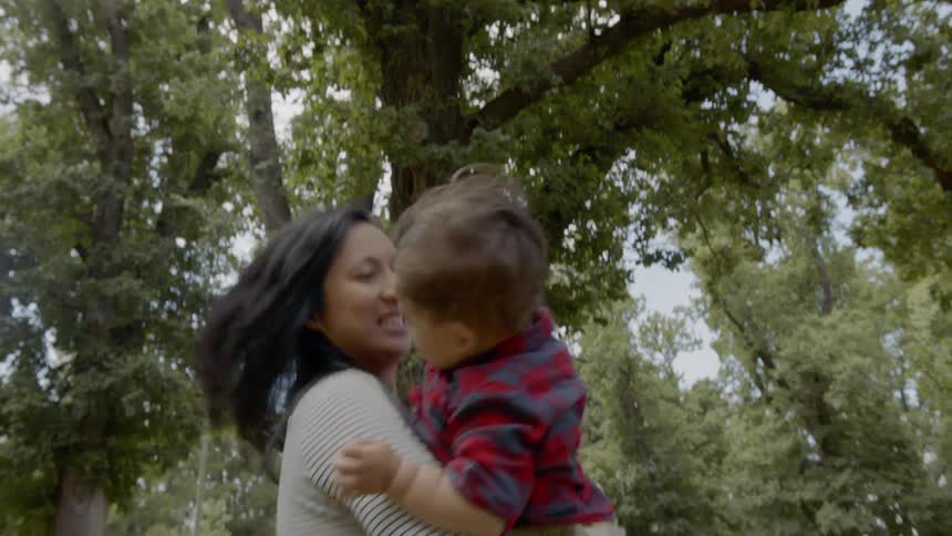 Mother hugging and playing with son on the park