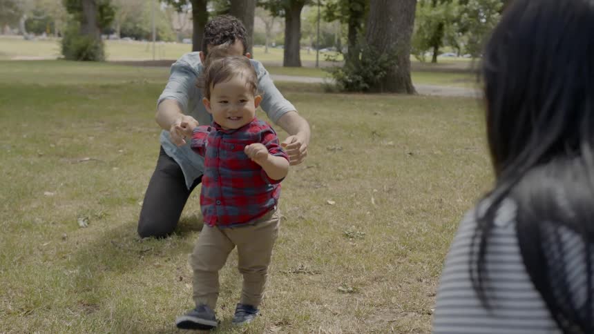 Mother father and son are playing outdoors