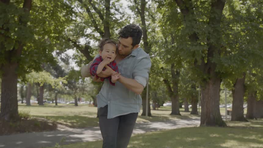 A father and son play in a park