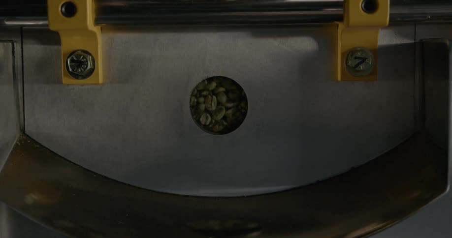 Coffee beans spin around inside a large machine