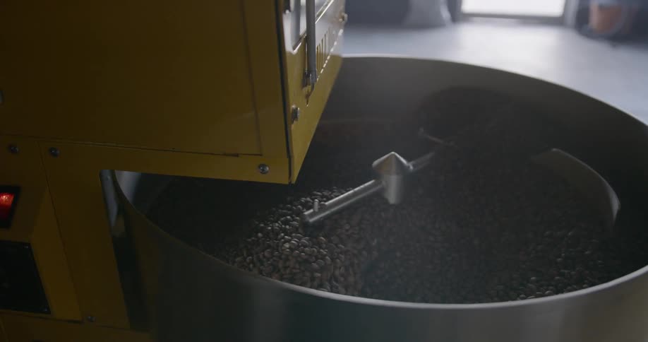 A machine mixing beans in a big bowl