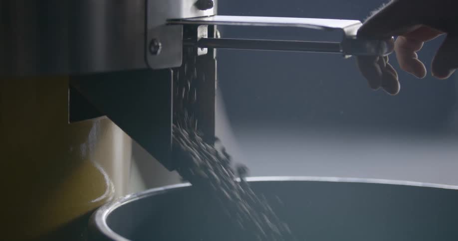 Coffee beans are being dispensed from a machine