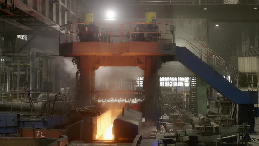 Machinery operates in a steamy factory