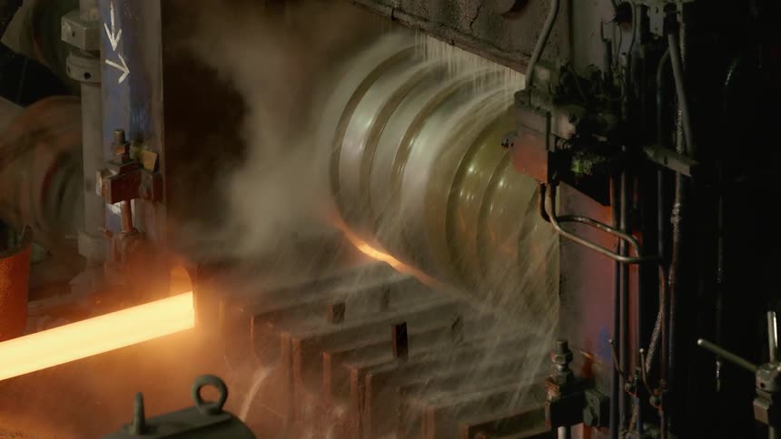 Water cools machinery working on glowing metal rod