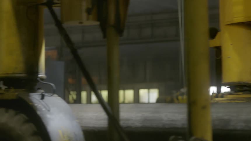 A heavy industrial vehicle moving through a factory