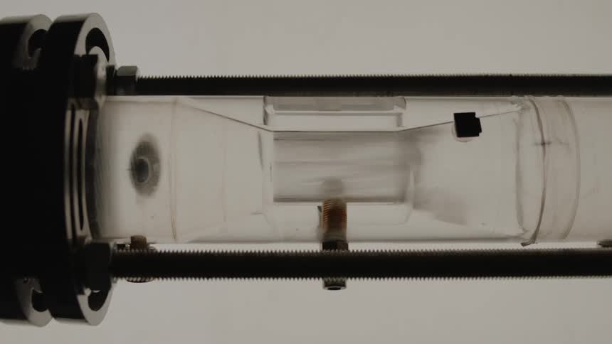 A vacuum tube with smoke going through it